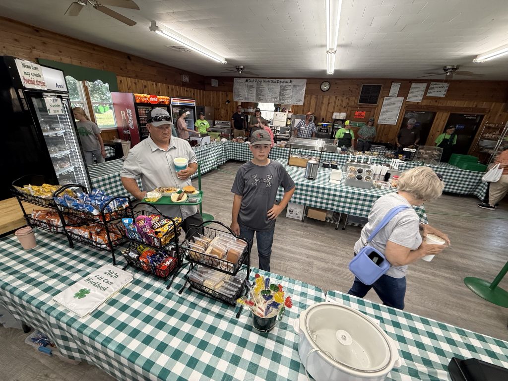 Gordon Lassen and his son go through the line at the Dawson County 4-H Cafe