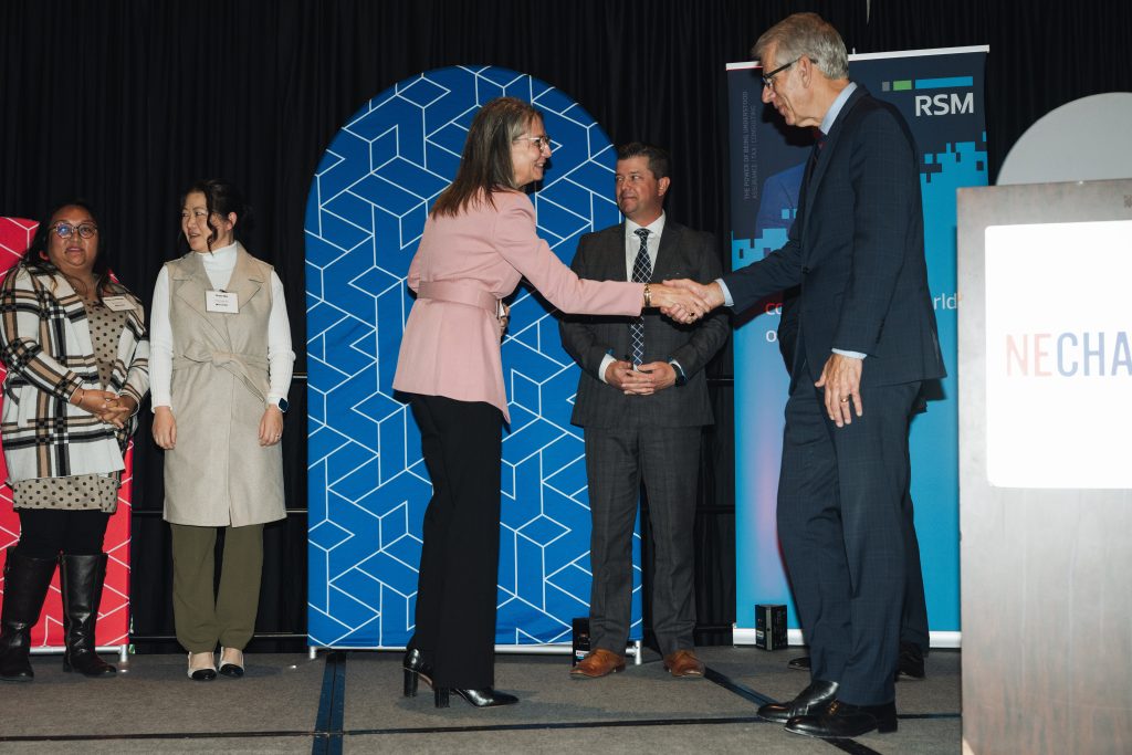 Teresa Grabowski, President & Co-Owner of Nova-Tech, shakes hands with Lieutenant Governor Joe Kelly.