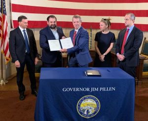 Gov. Pillen & Sen. Bostar sign bill offering protections against foreign threats